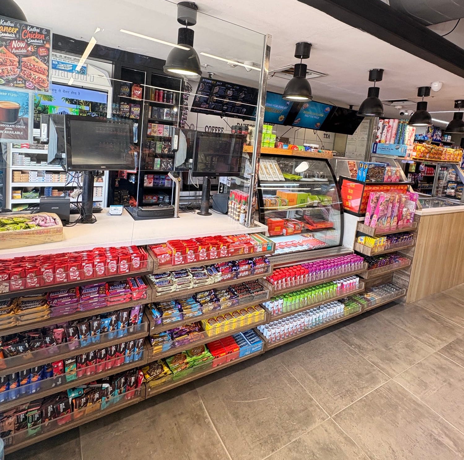 Inside a Storeex 24/7 store — Chill 24x7 bar, stocked aisles and the Storeex café wall