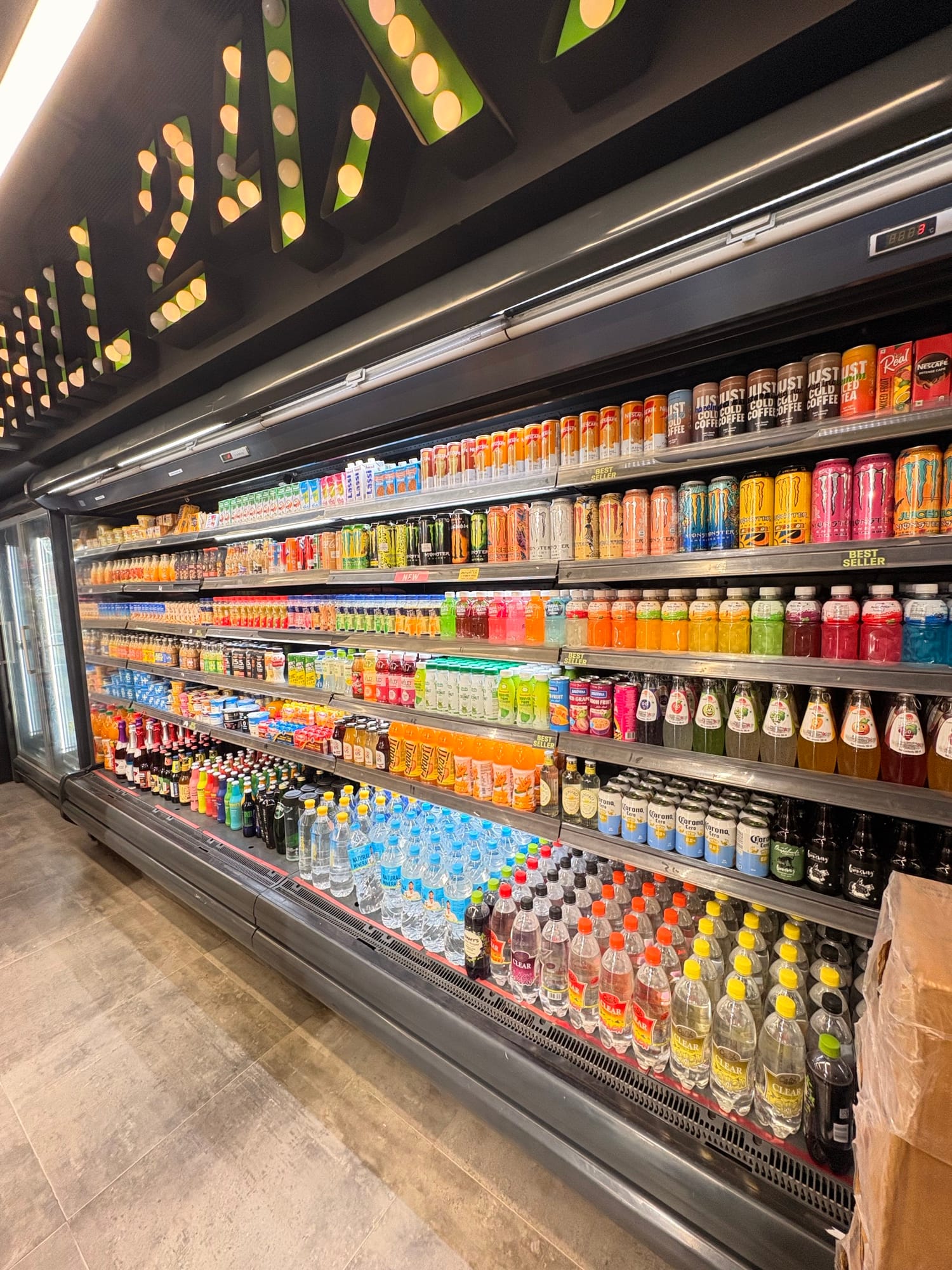 Open beverage chiller stocked with drinks